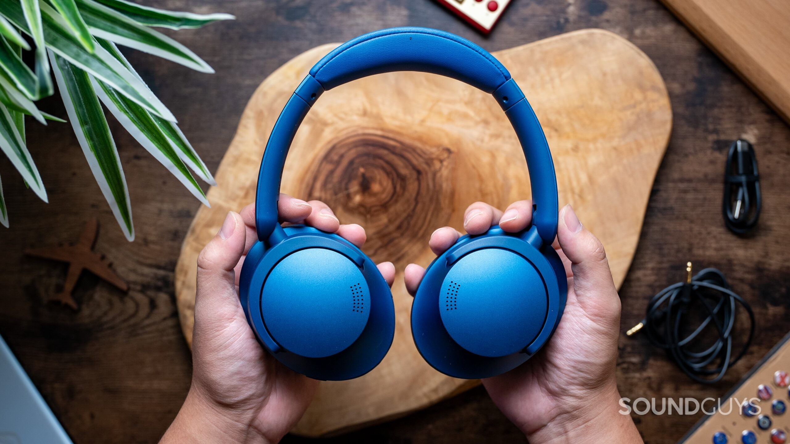 1MORE SonoFlow Headphones Featured Image #2 Top view of hands holding the SonoFlow headphones