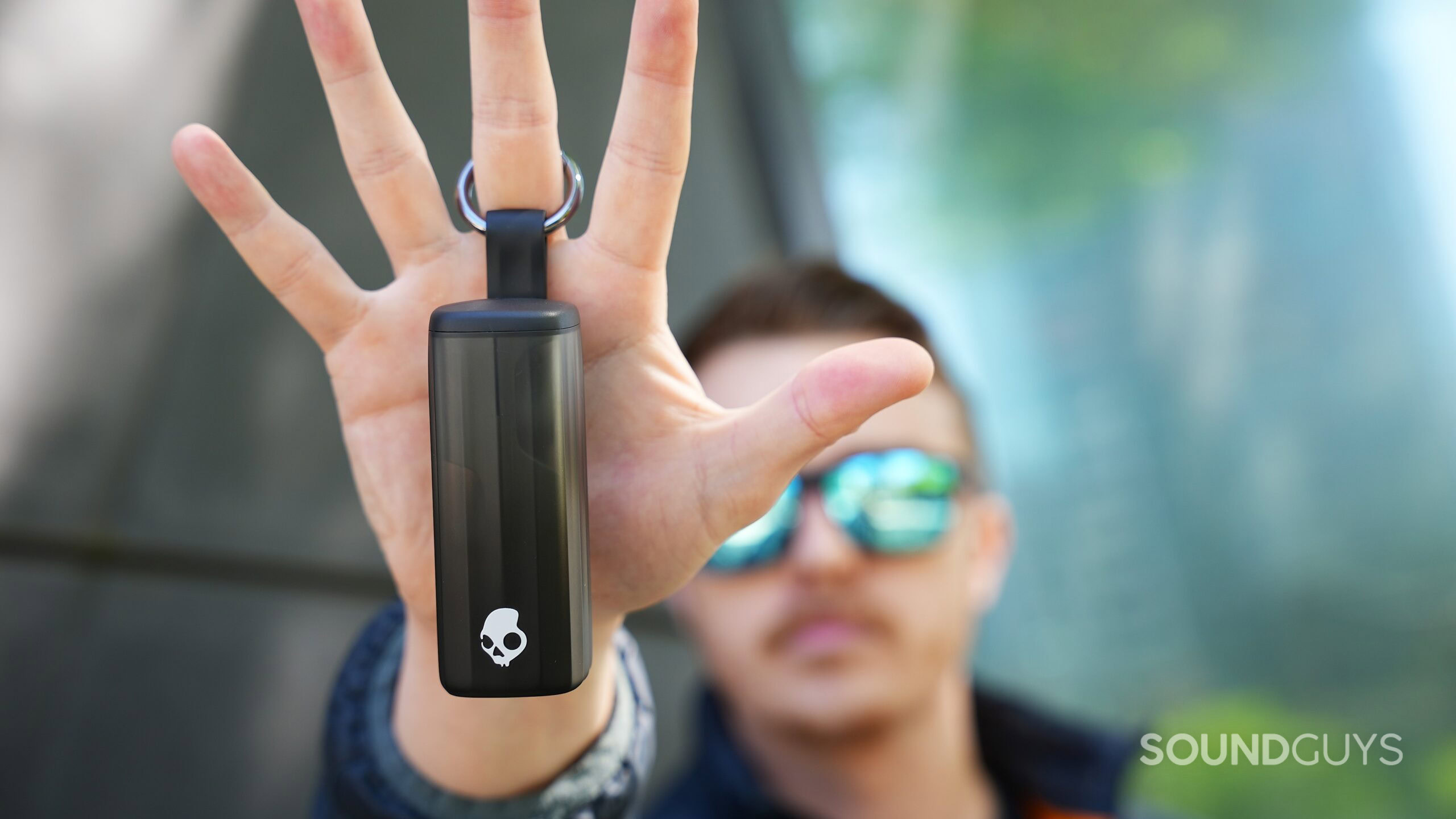 A hand holding up the skullcandy method 360 anc A hand holding up the skullcandy method 360 anc