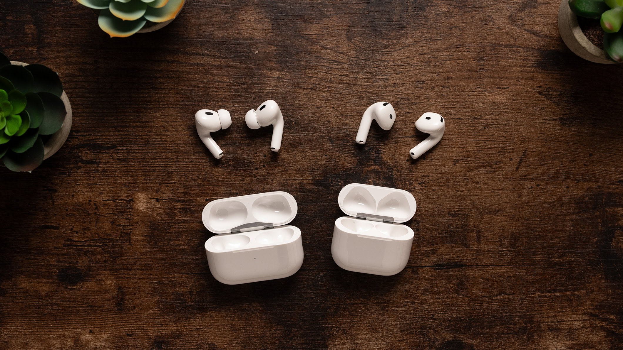 AirPods 4 vs AirPods Pro 2 earbuds next to case AirPods 4 with ANC next to the AirPods Pro 2 earbuds and charging case.