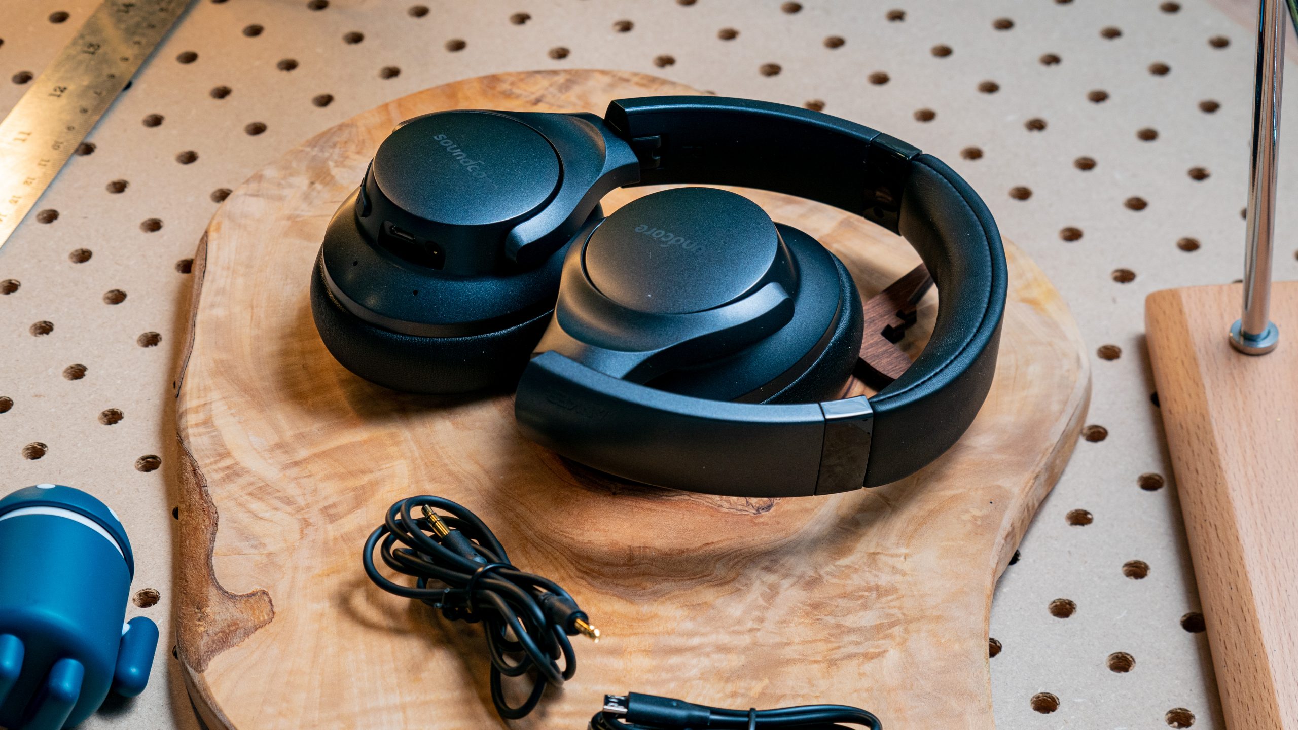 Anker Soundcore Life Q20 folded wireless headphones The Anker Soundcore Life Q20 wireless noise canceling headphones and cables on a wood surface.