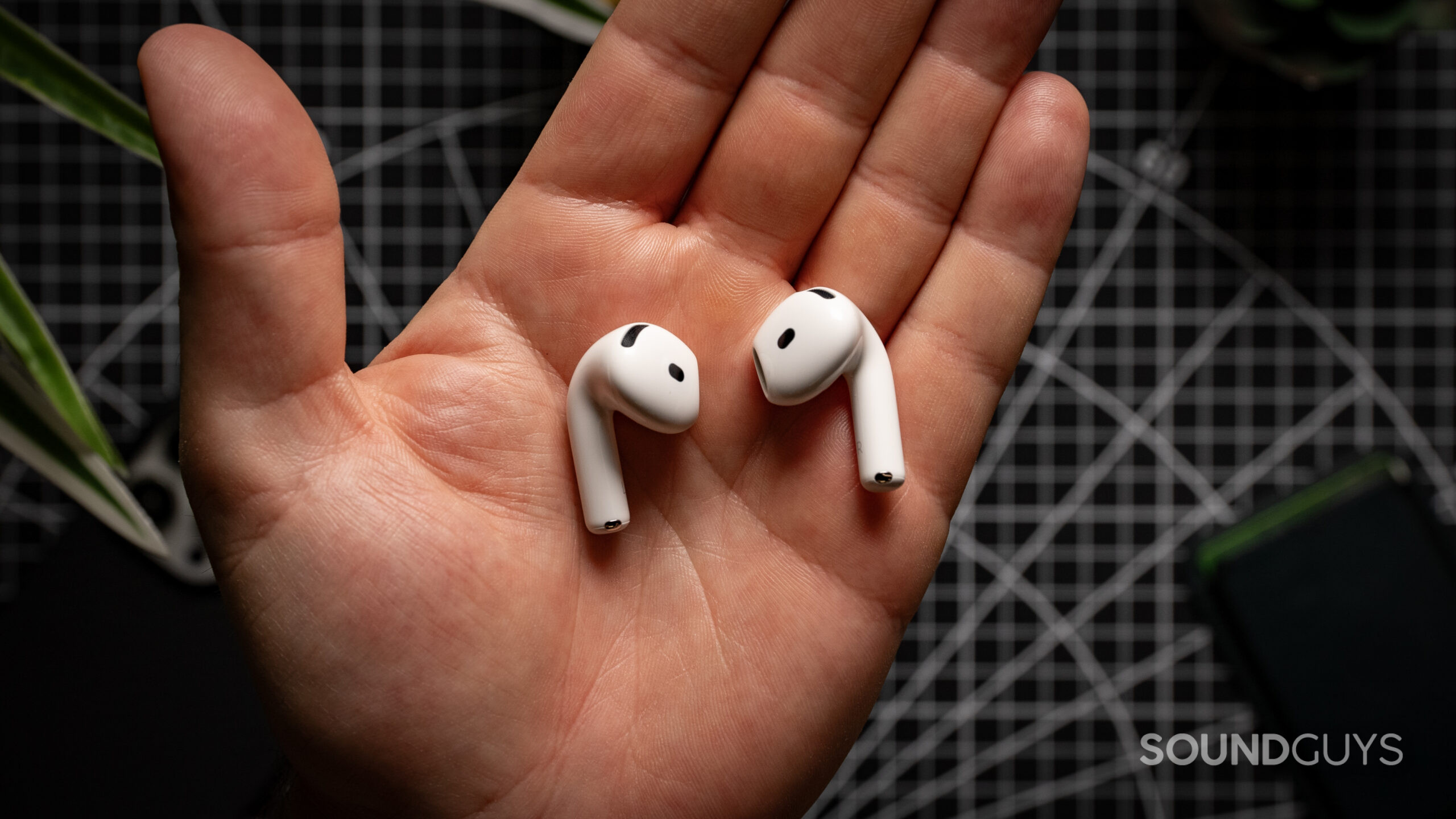 Apple AirPods 4 in plam hand AirPods 4 with Active Noise Cancellation earbuds in the palm of a hand.