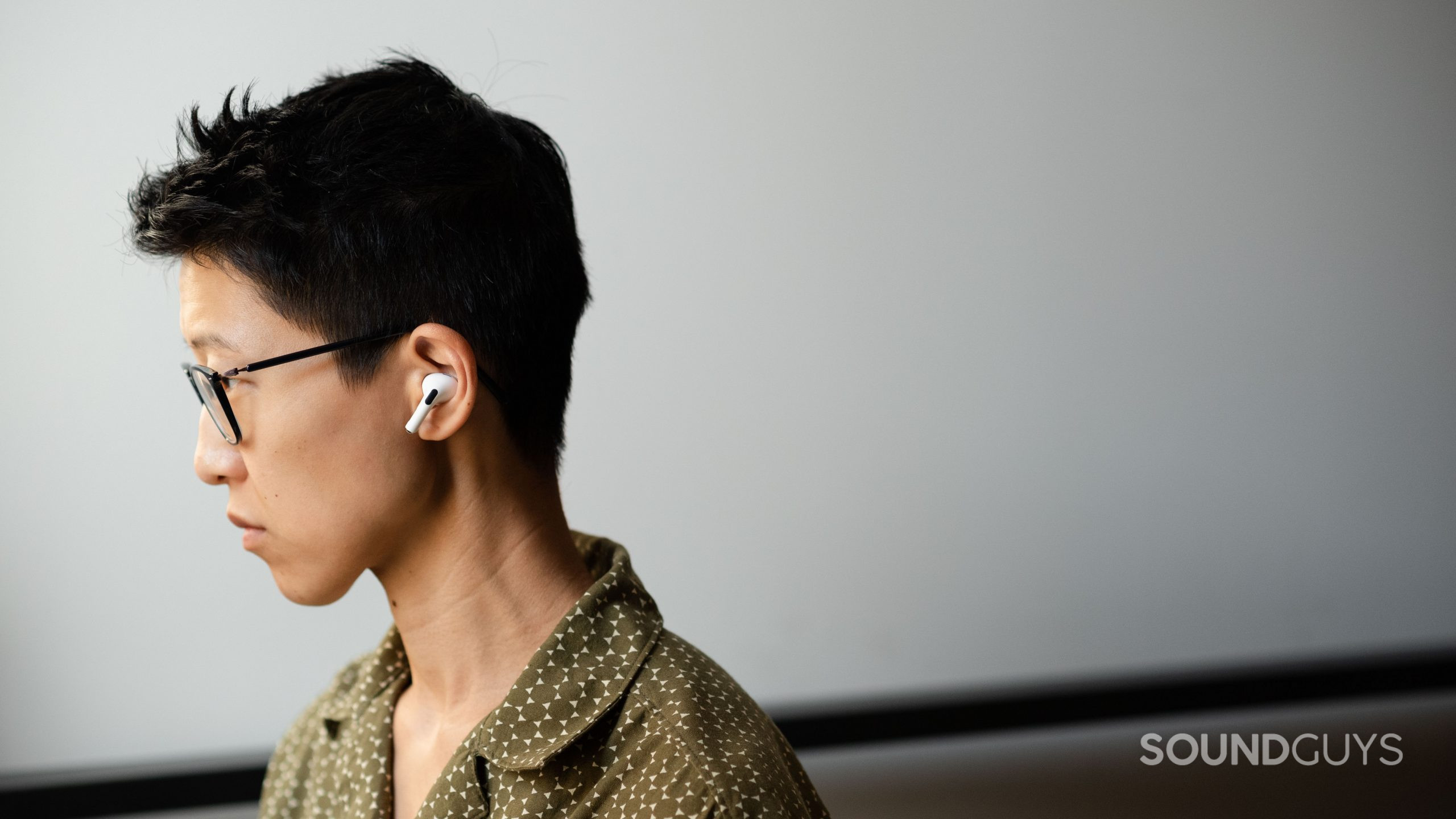 Apple AirPods Pro (2nd generation) true wireless earbuds person wears- (2) A person wears the Apple AirPods Pro (2nd generation) in profile view.
