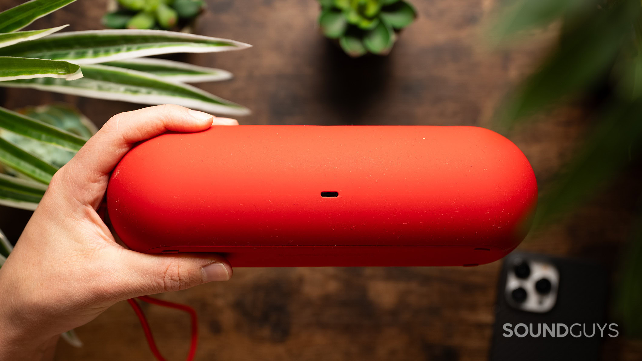 Beats Pill charging port A hand holds the Beats Pill showing its USB-C charging port.