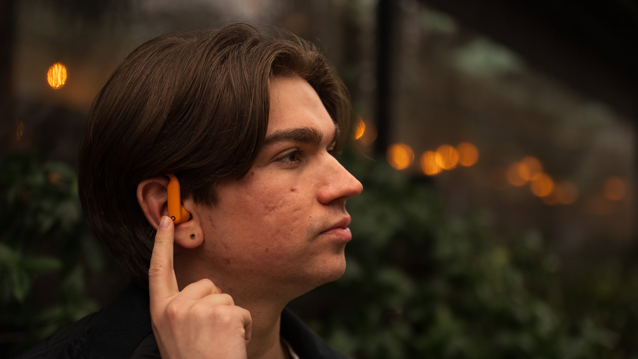 Beats Powerbeats Pro 2 touching the controls A man wearing the Powerbeats Pro 2 touches the controls.