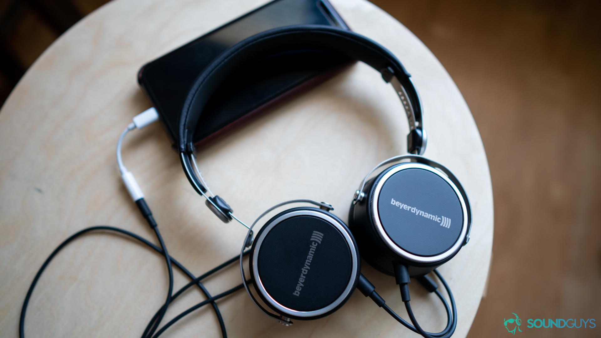 Beyerdynamic Aventho Wired-6 Aventho Wired headphones plugged into the dongle of the Apple iPhone X.