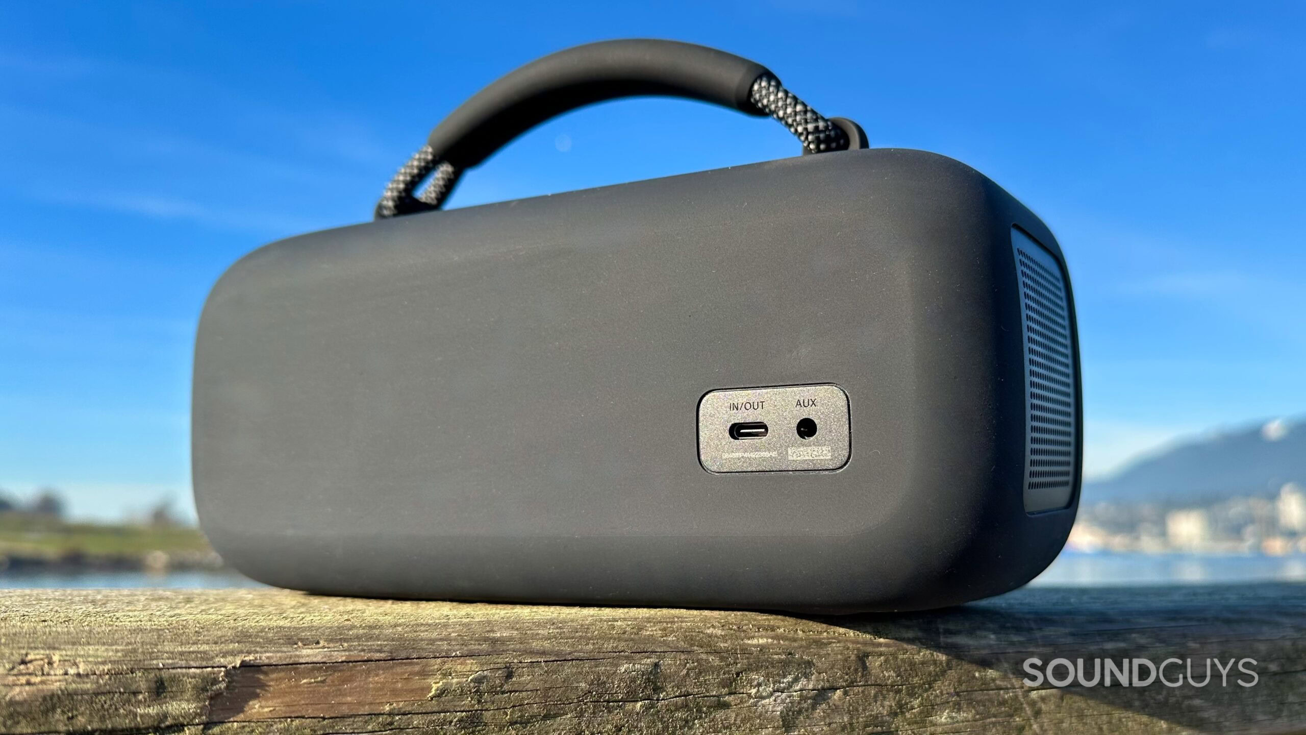 Bose SoundLink Max_2 Bose SoundLink Max on a pier, showing it's USB-C and 3.5mm jacks.