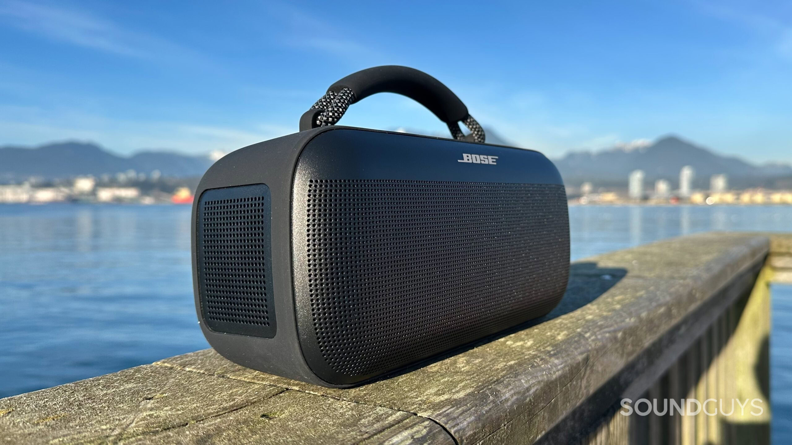 Bose SoundLink Max_3 Bose SoundLink Max on a pier, focusing on its passive radiators.