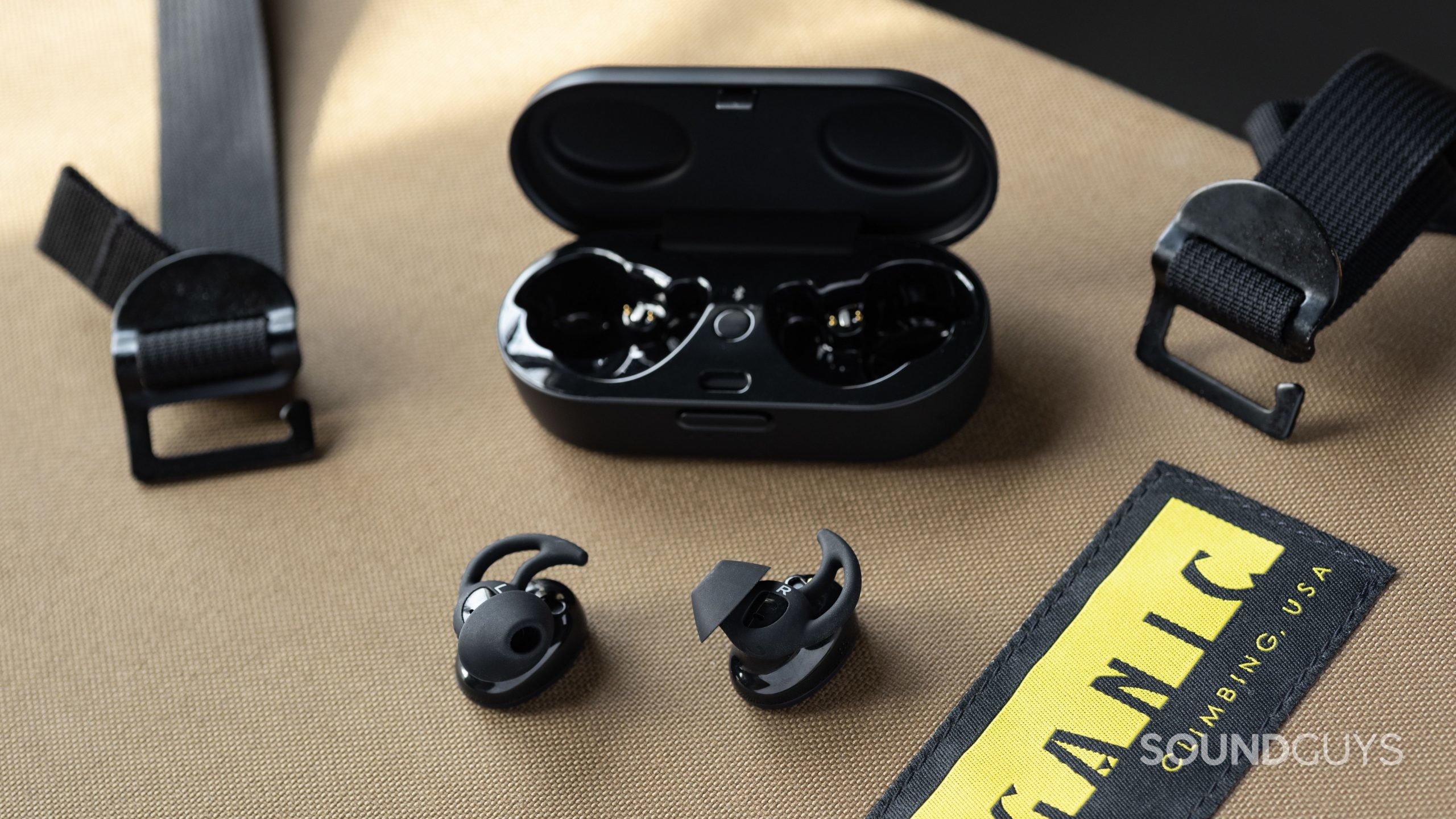 Bose Sport earbuds-6 The Bose Sport Earbuds true wireless workout earbuds outside of the open charging case; the earbuds are facing belly-up so the StayHear Max ear tips are in full view.