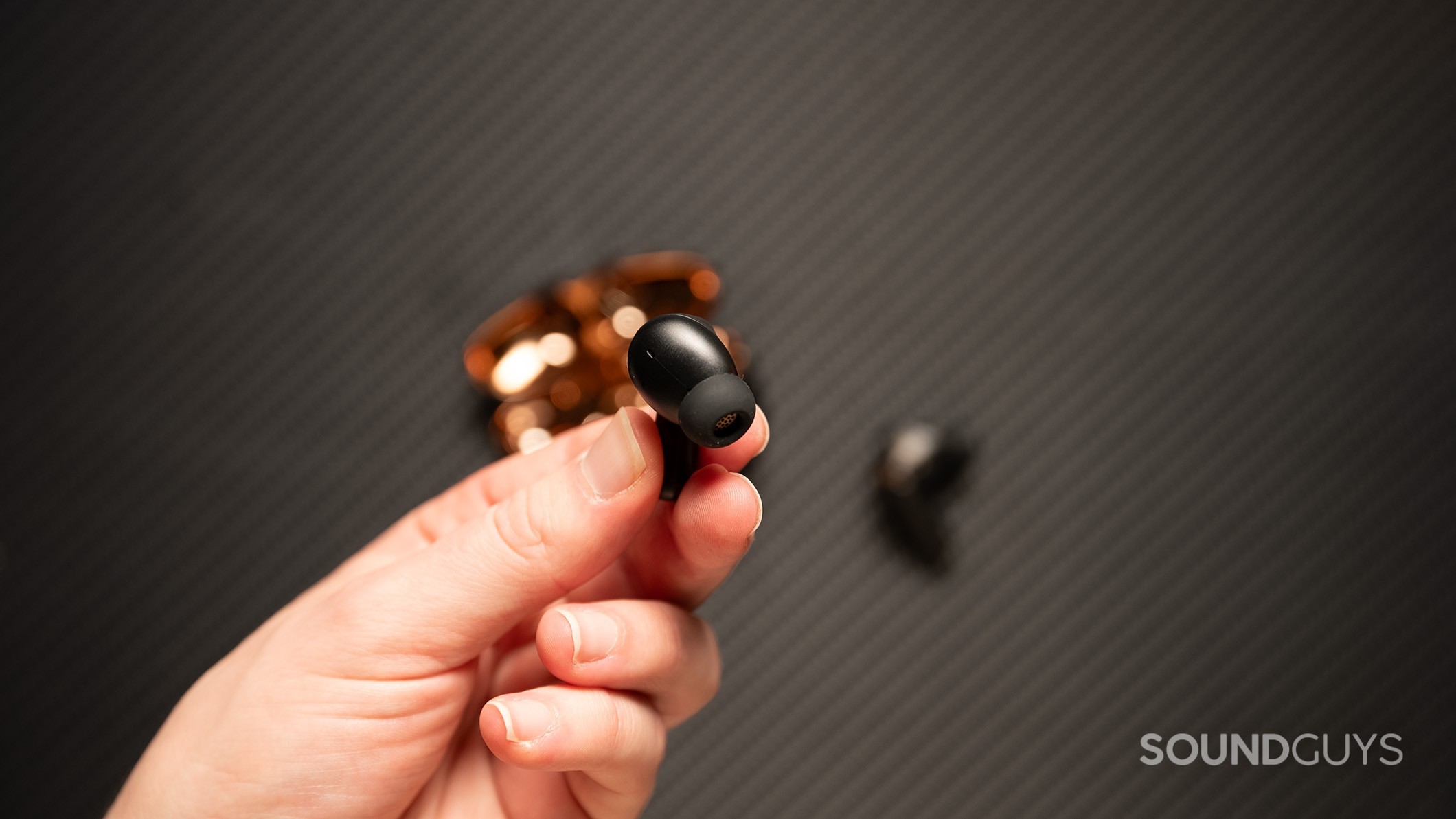 Creative Aurvana Ace 2 earbud in hand Creative Aurvana Ace 2 earbud held in a hand.