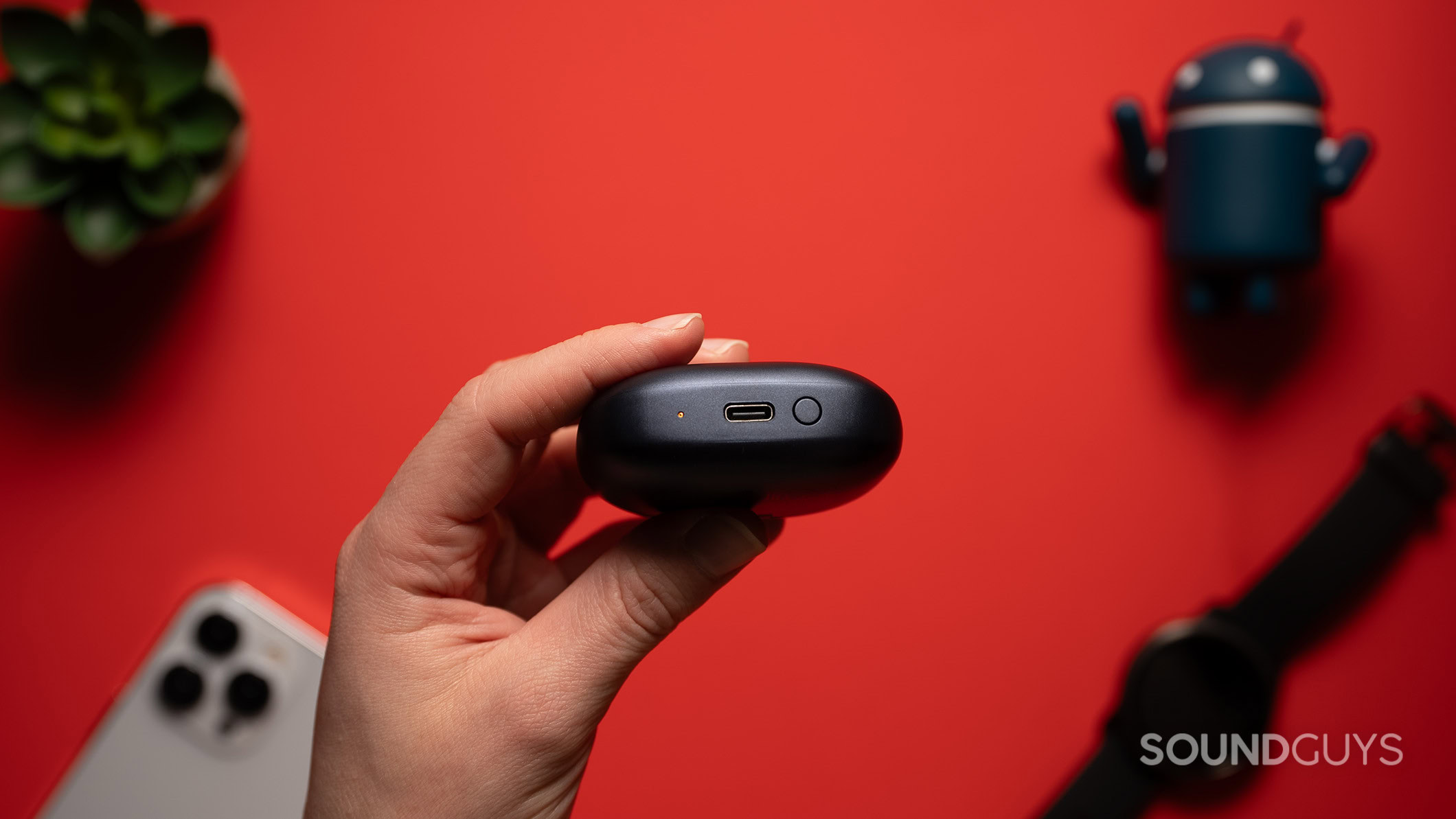 Creative Aurvana Ace Mimi charging port A hand holds the Creative Aurvana Ace Mimi charging case.