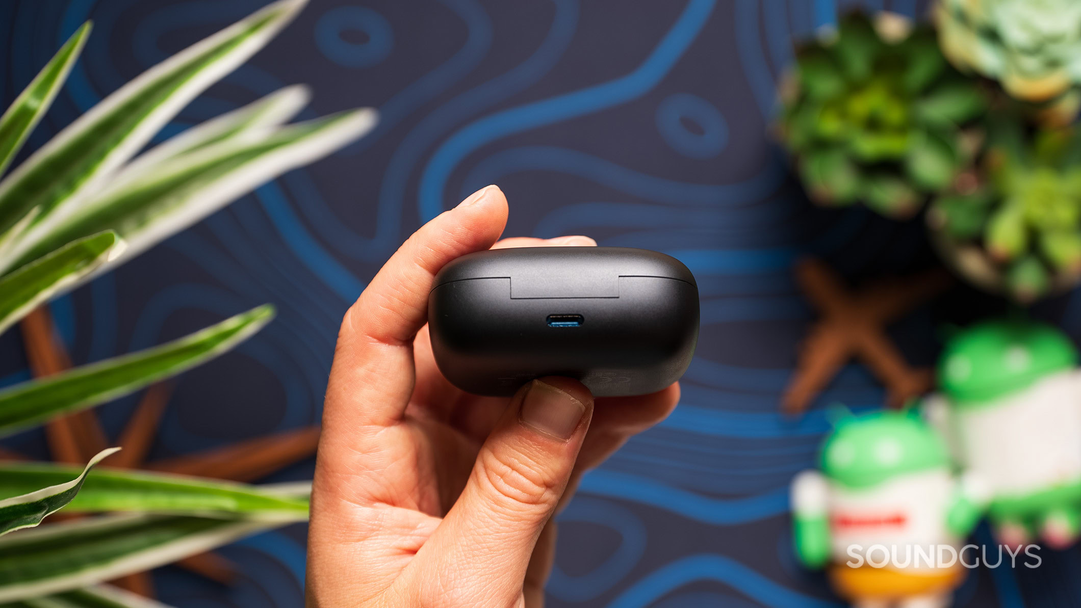 EarFun Air Pro 4 charging input A hand holds the EarFun Air Pro 4 charging case showing the USB-C input.
