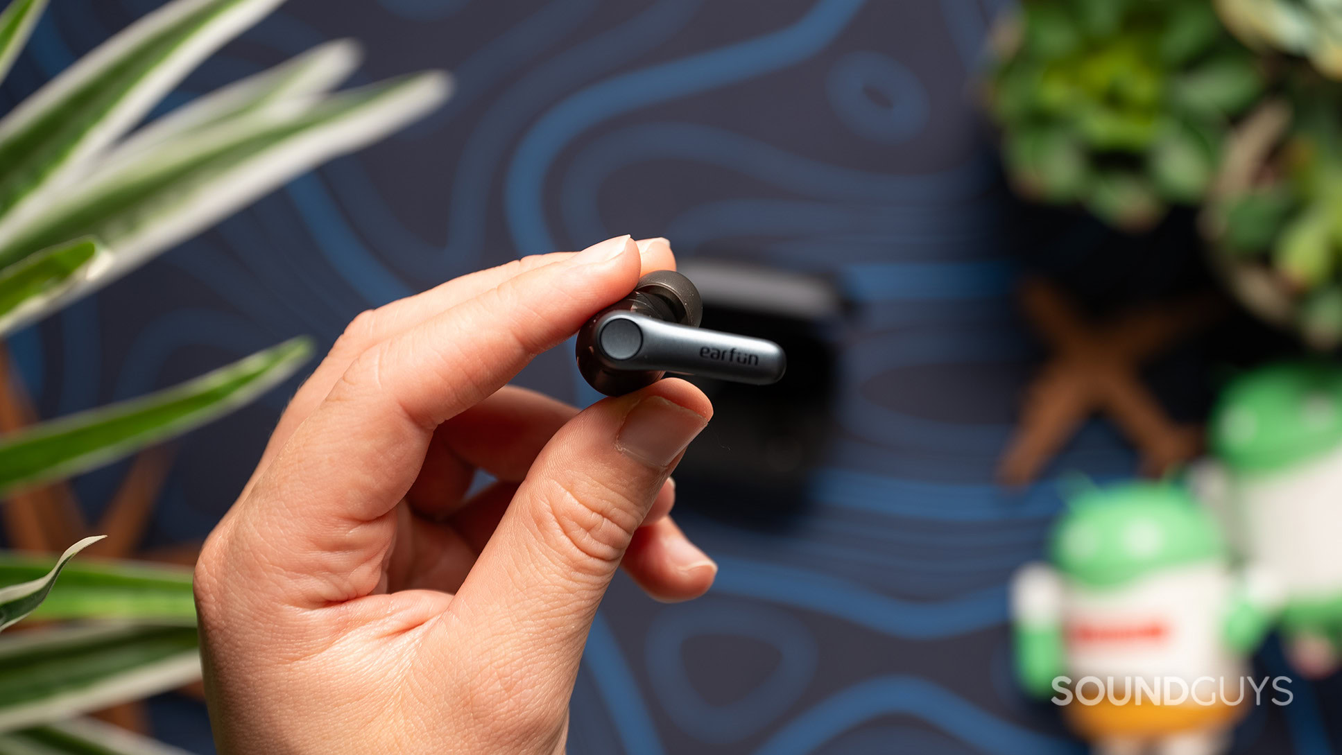 EarFun AirPro 4 earbud exterior A hand holding an EarFun AirPro 4 earbud.