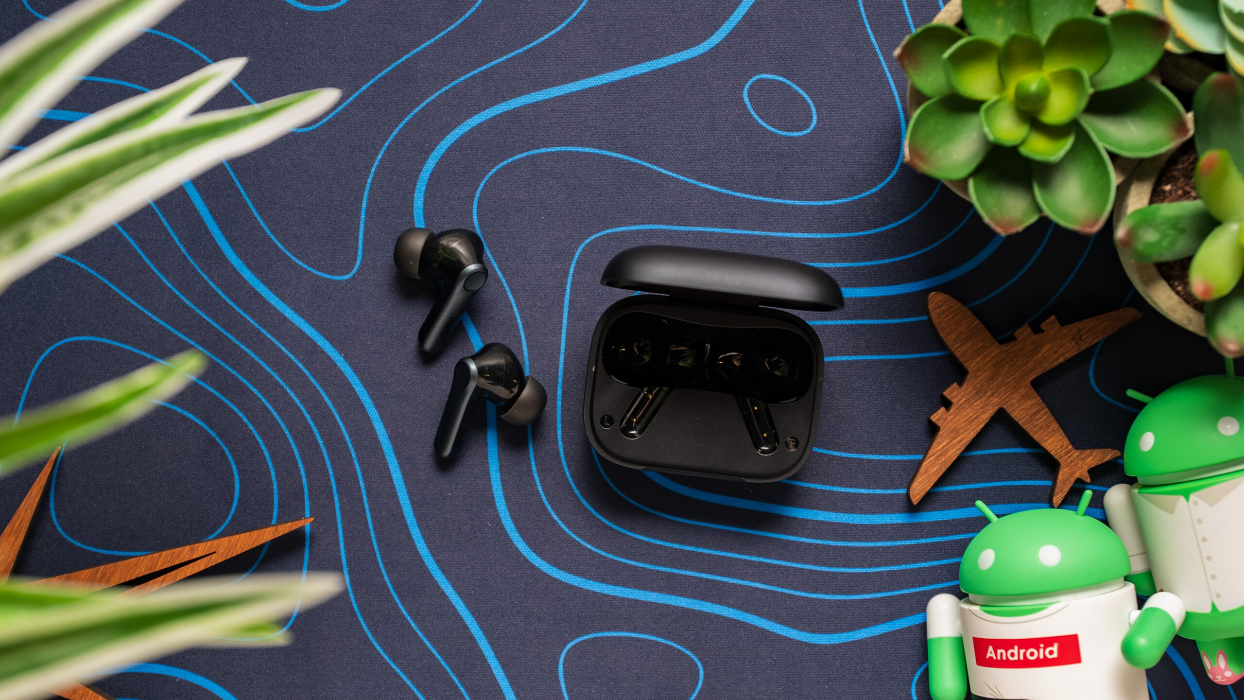 EarFun AirPro 4 earbuds next to case 2 The EarFun AirPro 4 earbuds next to their case.
