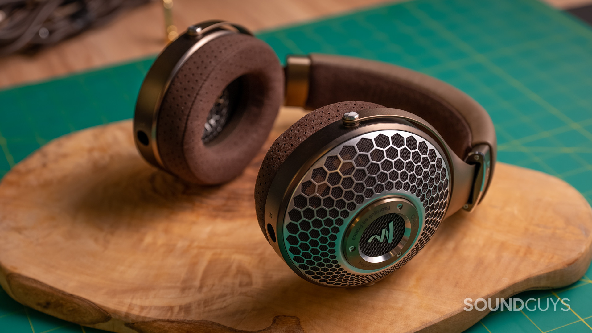 focal-clear-mg-hero A photo of the Focal Clear MG headphones lying atop wood.