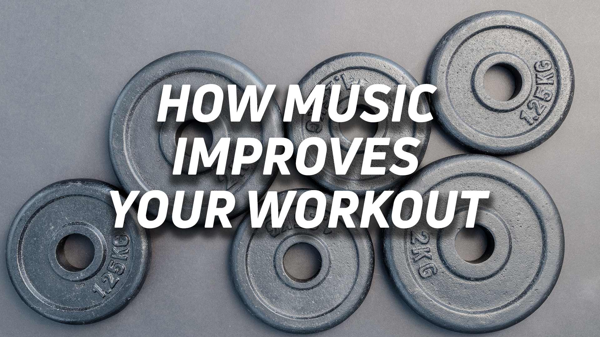 How music improves your workout hero Aerial view of free weights with the text "how music improves your workout" overlaid.