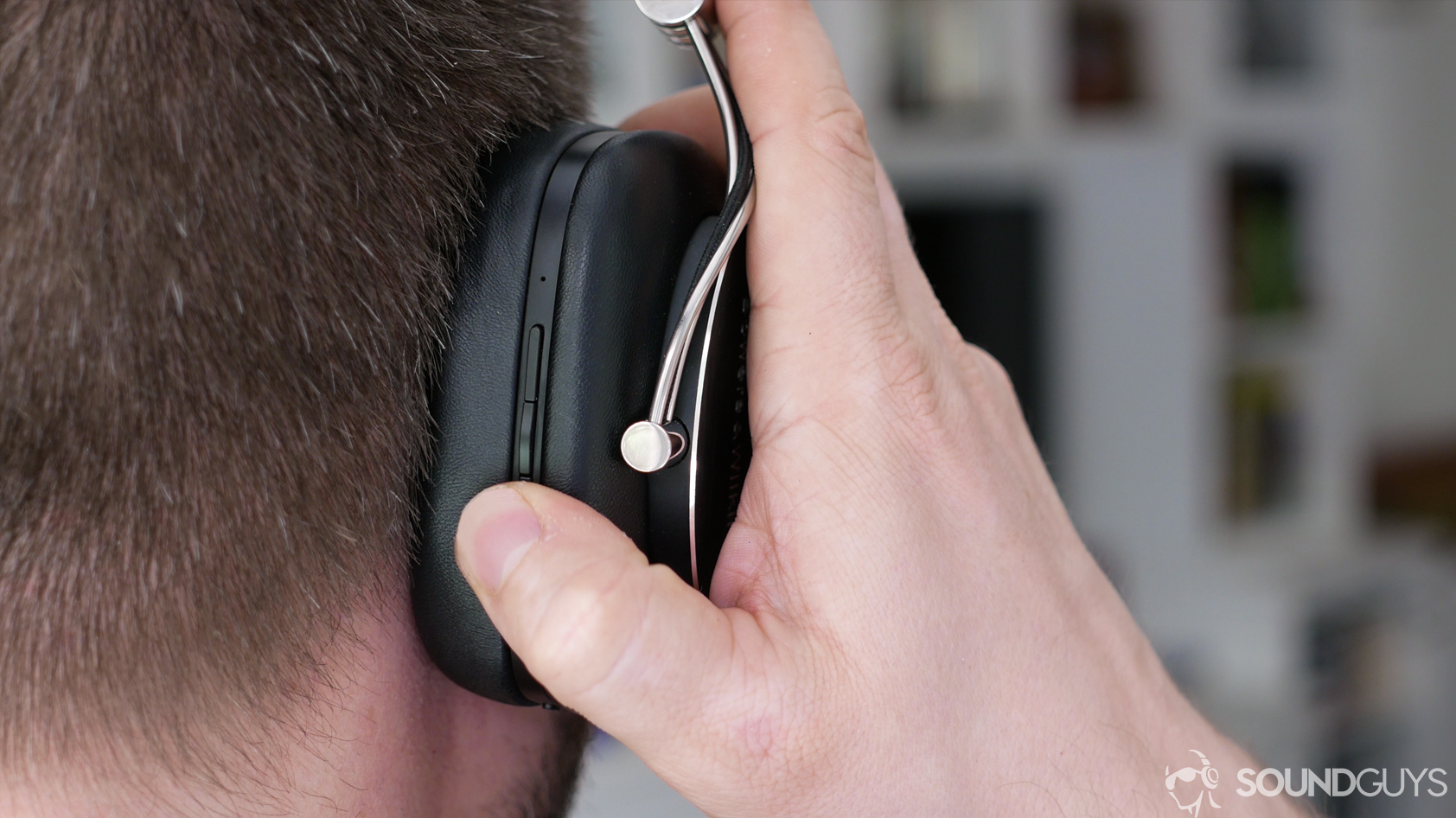 isolation-hero A man wearing a pair of Bowers & Wilkins over-ear headphones.
