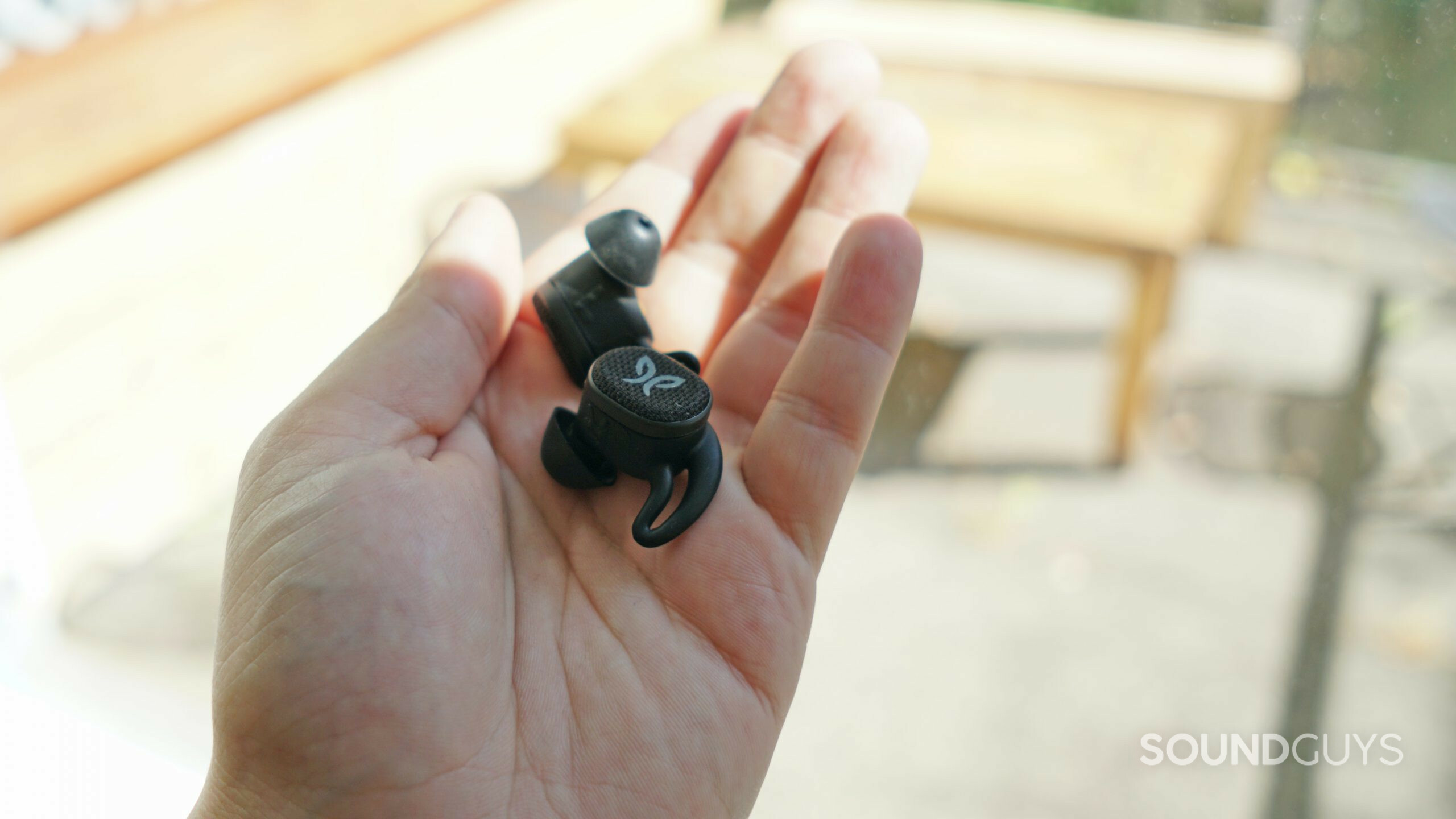 Jaybird-Vista-2-wingtip-hand Jaybird Vista 2 earbuds in hand outdoors.