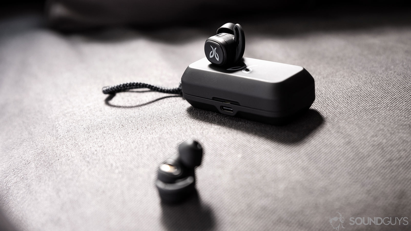 Jaybird Vista-3_earbuds charging case USB C An image of the Jaybird Vista earbuds outside of the case with one resting on top and the other in the foreground.