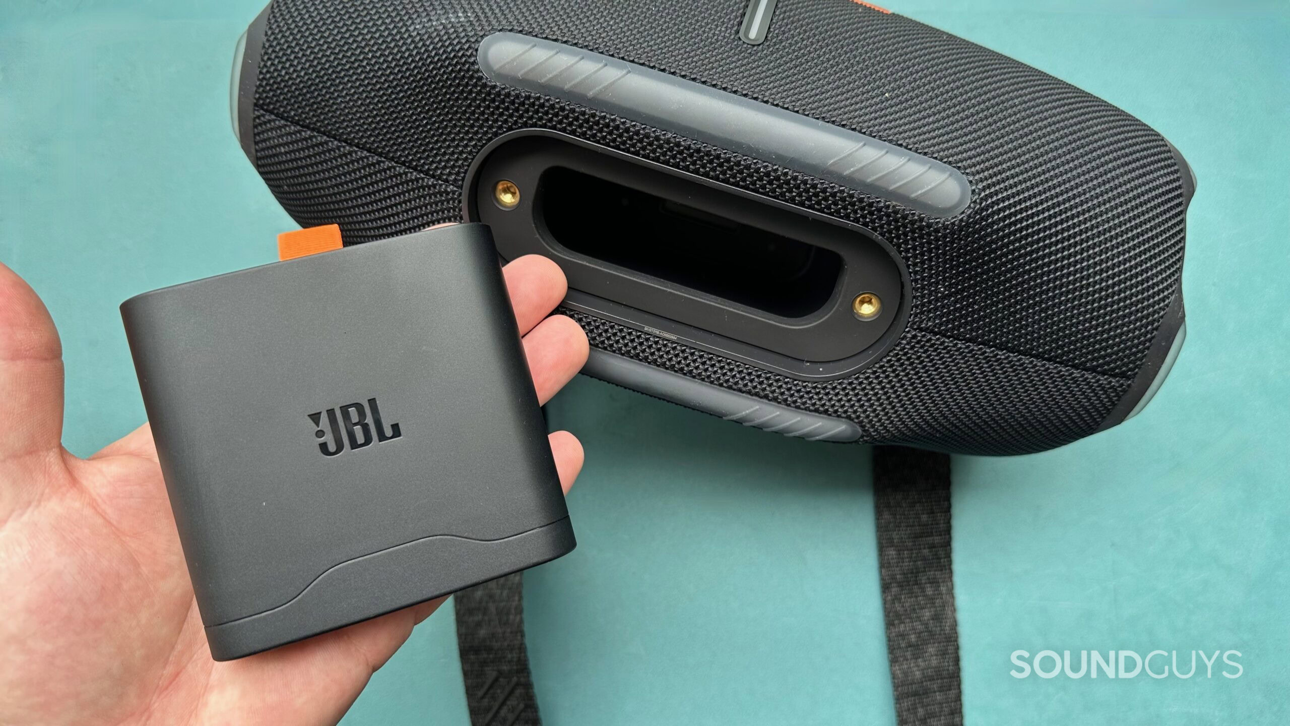JBL Xtreme 4 battery pack A hand holding a JBL battery pack that has been taken out of a JBL Xtreme 4 speaker.