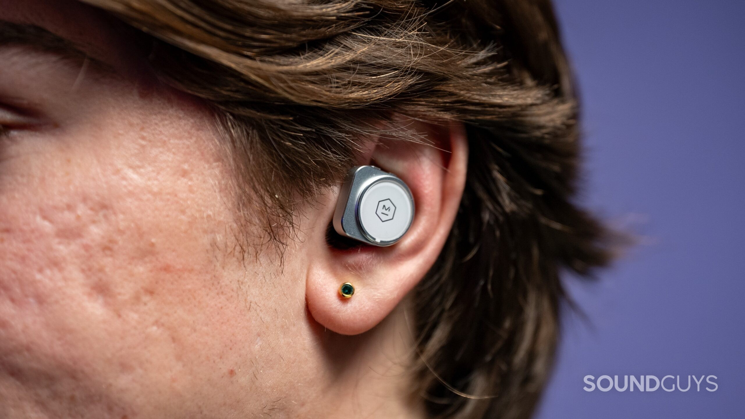 Master and Dynamic MW09 Model Image #1 Master & Dynamic MW09 earbuds in a human ear.