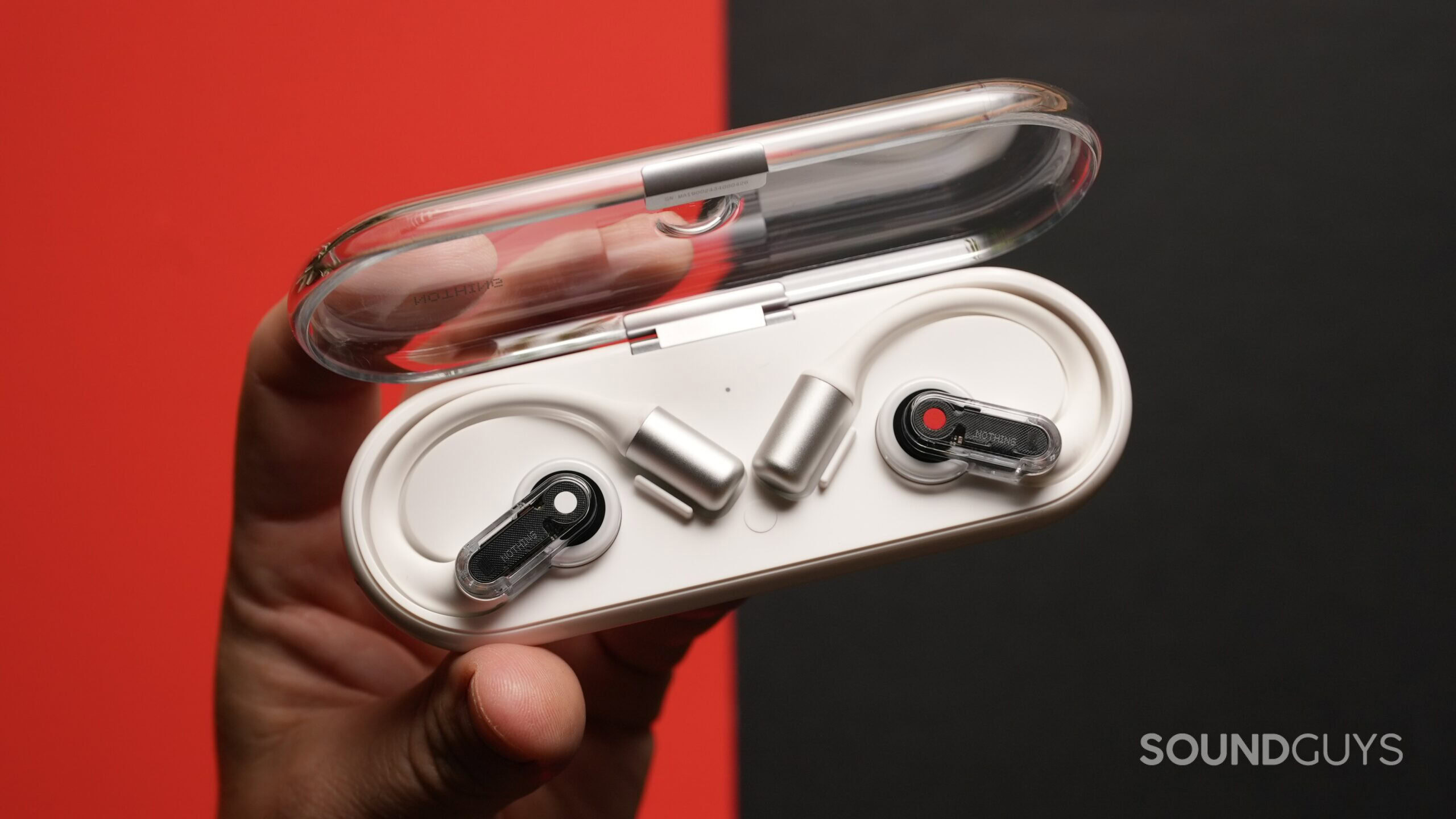 Nothing Ear (Open)_1.1 Top down shot of a hand holding the Nothing Ear (Open) earbuds in their charging case.