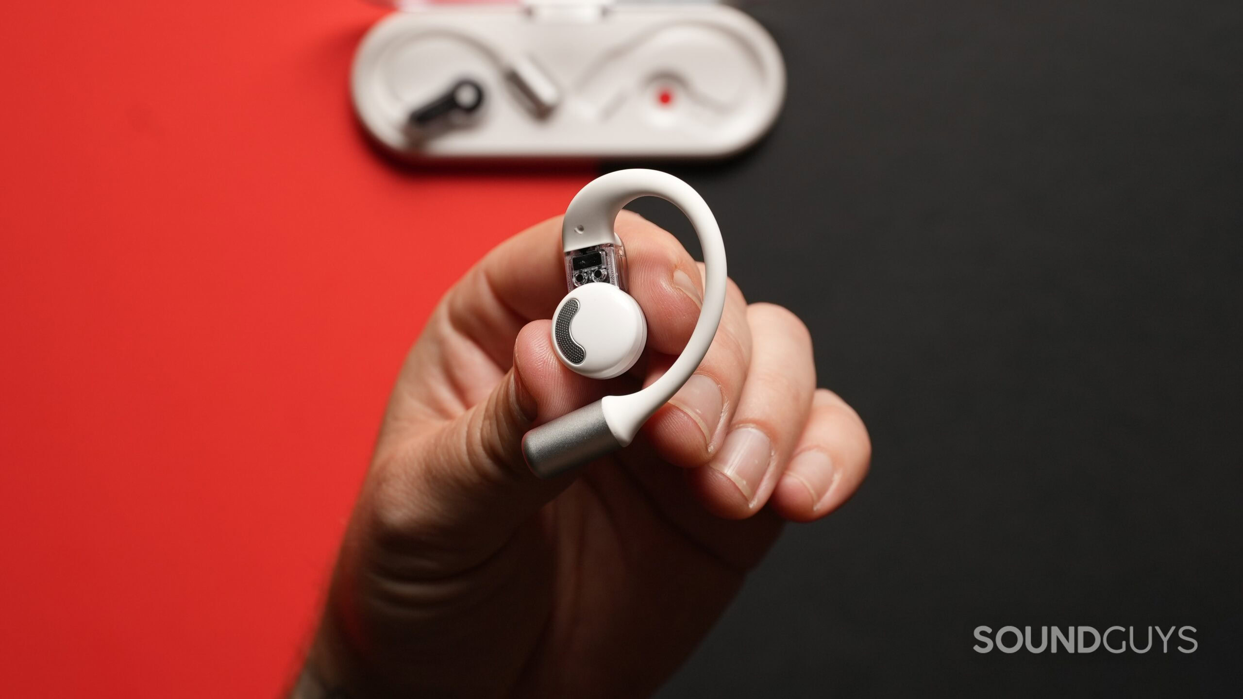 Nothing Ear (Open)_13 A hand holding a Nothing Ear (Open) earbud, showing its innerside.-