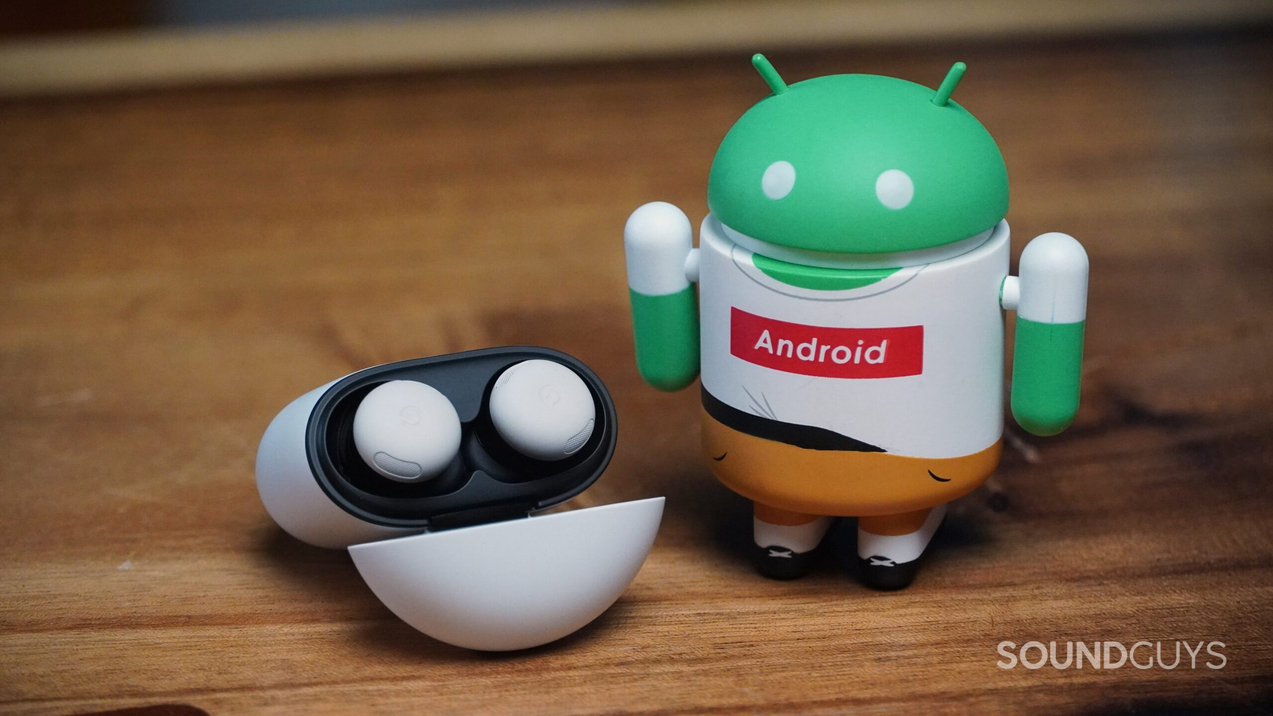 pixel buds pro 2 on table with android figure pixel buds pro 2 on table with android figure
