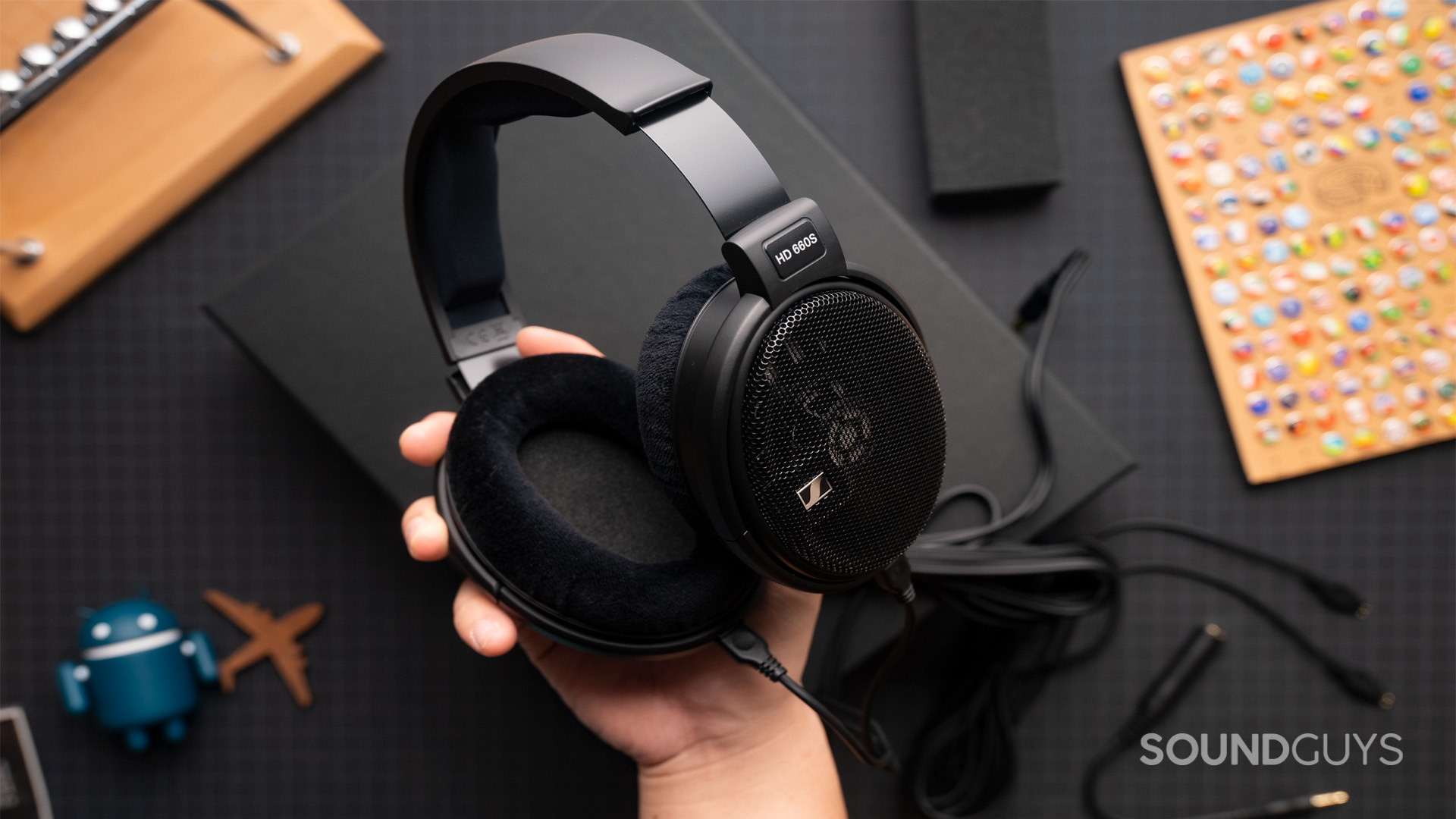 Sennheiser HD 660S hands hold angle open-back headphones The Sennheiser HD 660S shown held in one hand.