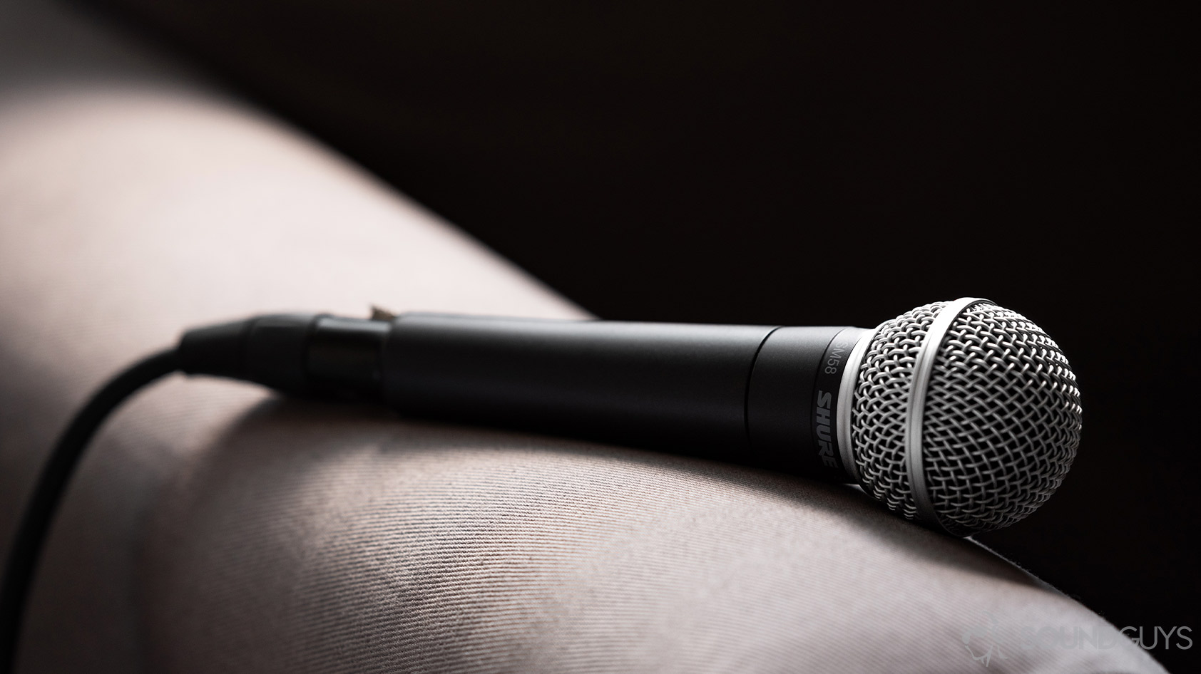 Shure SM58 dynamic microphone A photo of the Shure SM58 on the arm of a couch.