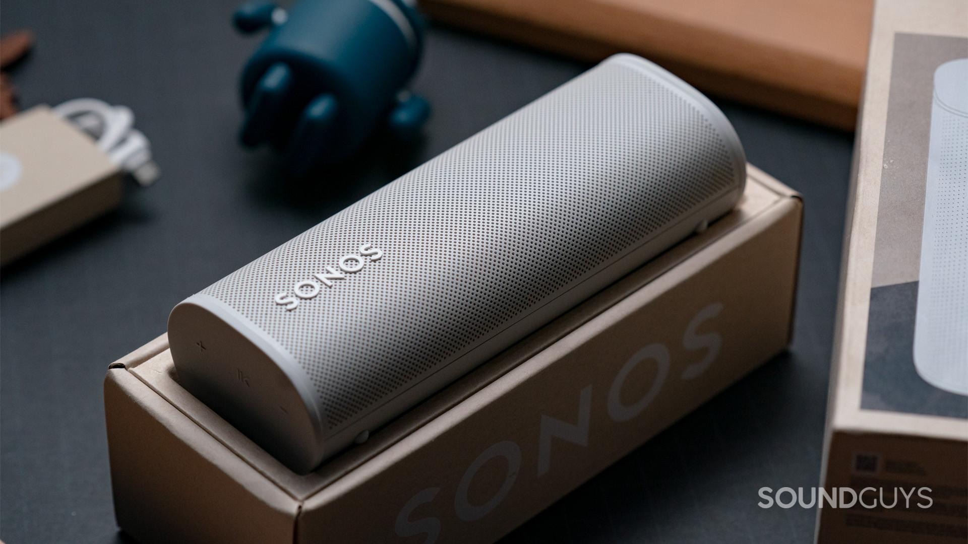 Sonos Roam Bluetooth smart speaker box A white Sonos Roam speaker sitting face-up inside of the box it came in.