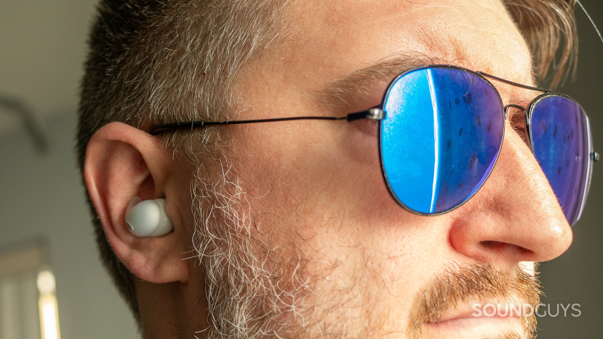 sony-linkbuds-fit-wear A photo of a man wearing sunglasses and the Sony LinkBuds fit.