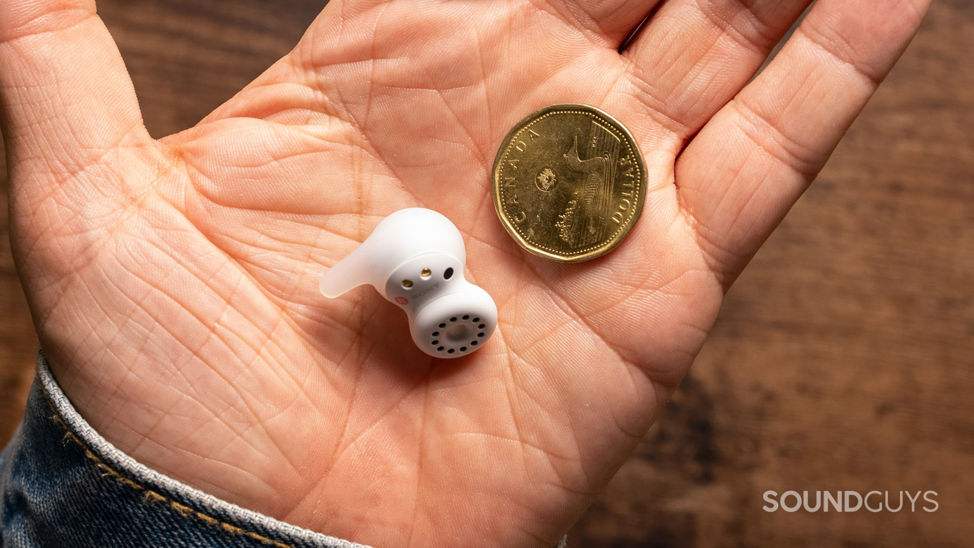 sony-linkbuds-open-hand A photo of the Sony LinkBuds Open in a man's hand, next to a Canadian $1 coin.