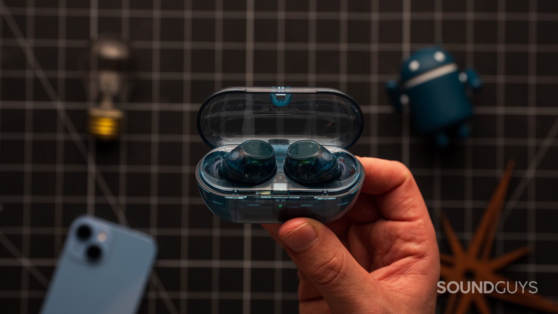 Sony WF-C710N earbuds in case A hand holds the Sony WF-C710N earbuds in the charging case.