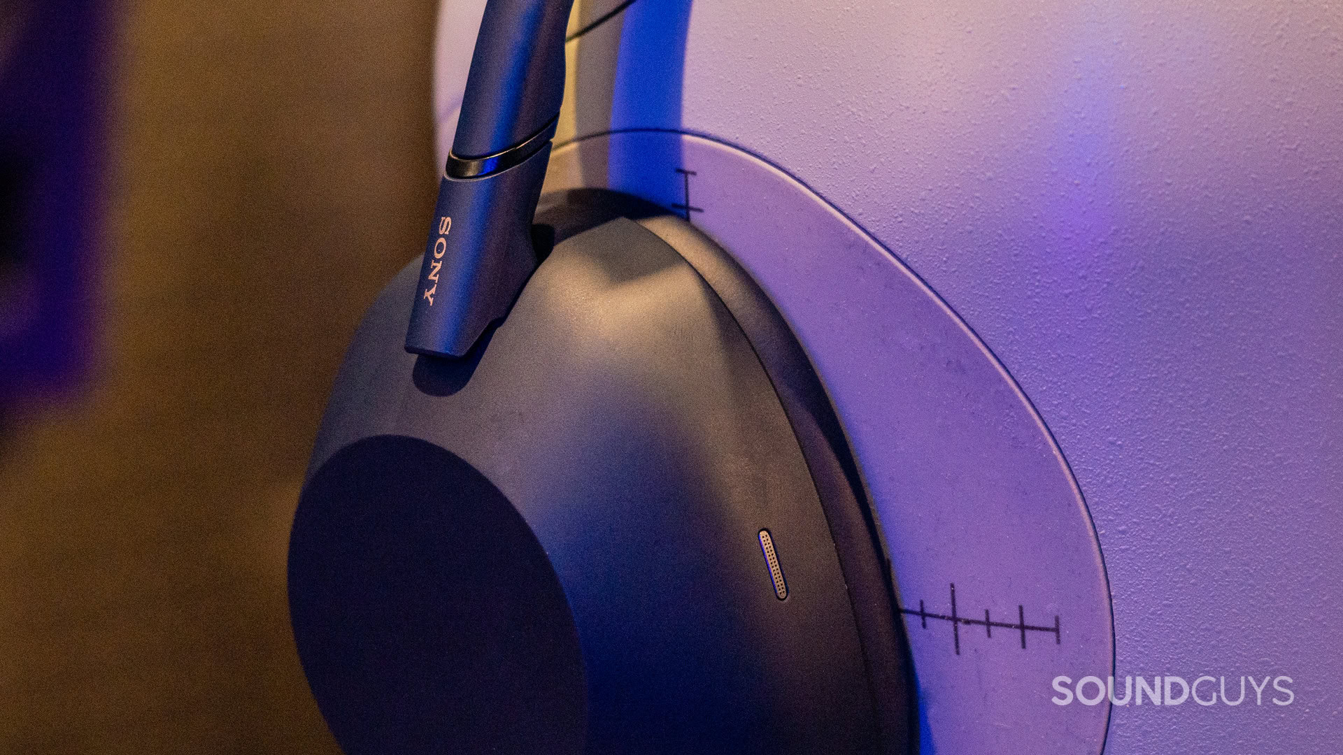 A close-up of the Sony WH-1000XM6 in the lab, with its pads compressed.