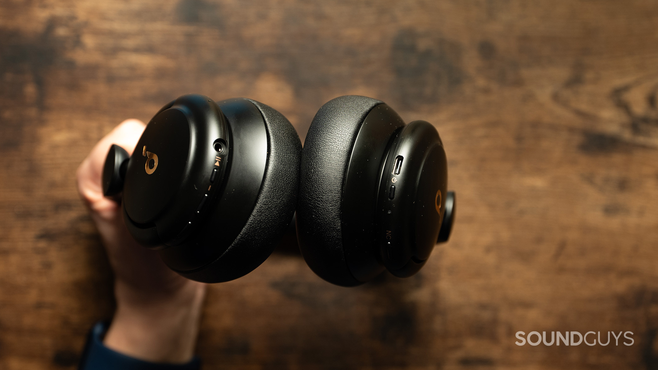 Soundcore Life Q30 held in hand cropped A hand holds the Anker Soundcore Life Q30 headphones.