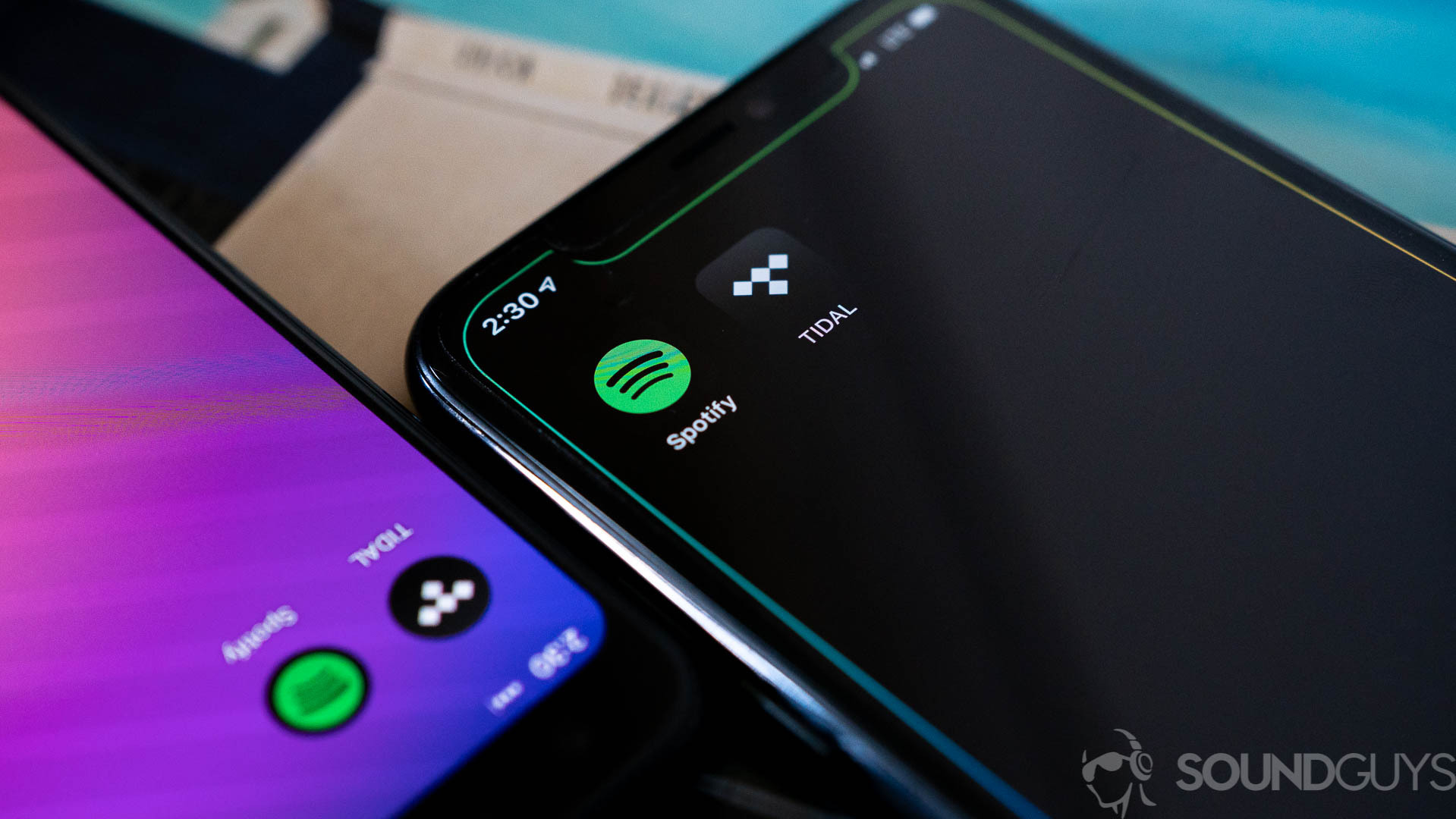 Spotify vs tidal (2 of 3) Spotify and Tidal's app icons on two smartphones